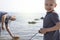 Dad and son launch a ship on the radio. Father shows the boy how to play with the boat on the remote control. The concept of