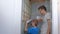 Dad and son make renovation together at home, remove tiles from walls in toilet.