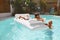 Dad And Son In Pool Enjoying Summer Entertainment. Family Vacation At Tropical Resort.