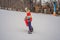 Dad and son ride the same snowboard, breaking safety precautions