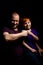 Dad and son are smiling and banging their fists against each other on a black background. Parent-child interaction. Father`s day