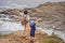 Dad and son tourists on the background of beautiful rocks and the sea. Hiking concept. Tobizin cape. Vladivostok, island