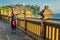 Dad and son travelers in Pura Luhur Uluwatu temple, Bali, Indonesia. Amazing landscape - cliff with blue sky and sea