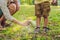 Dad and son use mosquito spray.Spraying insect repellent on skin outdoor