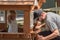 Dad squatting into daughters playhouse