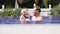 Dad swims with his little daughter in the pool