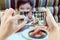 Dad take mobile photo of Asian boy eating French fries