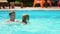 dad teaches his daughter to swim in the pool. games and activities in the water.