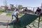 A dad teaches his young son to skateboard with his eldest son for three years