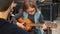 Dad teaching guitar and ukulele to his daughter.Little girl learning guitar at home.Close up.Ukulele class at home