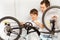 Dad teaching son repairing bicycle using spanner