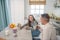 Dad and teen daughter talk at the table after breakfast.