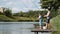 Dad and teenage boy angling together on lake