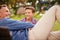 Dad tells the best stories. a father and son talking together while lying in a park.