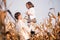 Dad toss daughter up in autumn corn field