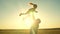 Dad tosses a happy child up into the sky at sunset. Daddy s daughter flies in his arms soaring in the air playing the