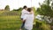 Dad and two children walk together in the green garden near the house.