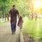 Dad walks with his daughter in park