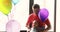 The daddy with the baby boy look at a balloon