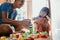 Daddy and child playing with plastic brick