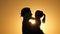Daddy is circling his beloved healthy daughter in his arms. silhouette of dad and child at sunset. happy father and