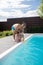 Daddy helping his cute girl using water pistol