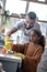 Daddy smiling while cute daughter cleaning kitchen