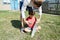 Daddy teaching boy in machete sharpening