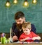 Daddy teaching his son how to paint. Cute kid watching his father painting