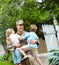 Daddys home. An army father at home in the garden hugging his two children.