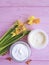 Daffodils cream cosmetic overhead product facial mask capsules on pink wooden natural