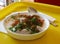 Dahi vada indian snack spicy on white plate side view natural light