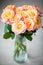 Dainty yellow-pink roses in a vase