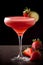 The Daiquiri in glass on a table, Spanish cocktail with strawberry and lime. Dark background. Refreshing alcoholic drink close-up