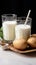 Dairy alternative Two glasses with powdered vegan potato milk showcased
