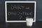 Dairy or dairy-free debate, text on blackboard with glass of milk from topdown perspective