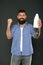 Dairy foods are good sources of protein and calcium. Bearded man holding bottle of dairy drink on grey background. Happy