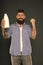 Dairy foods are good sources of protein and calcium. Bearded man holding bottle of dairy drink on grey background. Happy