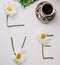 Daisies, coffee and the word `Love`