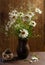 Daisies in vase and blueberries in basket