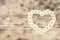 daisy flowers heart shaped on wooden background