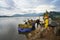 Dak Lak, Vietnam - Oct 22, 2016: Farmers are loading harvested rice from floating boat up to transport vehicle in Lak district