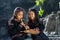Daklak, Vietnam - Mar 9, 2017: Two Ede ethnic minority little girls learning to play the flute in forest. The Ede have long lived
