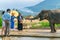 DALAT, VIETNAM - APRIL 15, 2019: Tourists feed elephant with mountain in the background in Dalat Vietnam