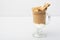 Dalgona Coffee Iced, Korean trendy fluffy creamy whipped, white background. cinnamon. Direct view