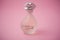 Dalimix perfume from Salvator dali brand in transparent bottle on pink background