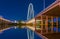 Dallas night lights reflect in water under bridge