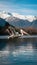 Dalmatian Pelican Flying Over Serene Lake with Snow Capped Mountains