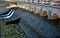 The dam of the breeding fish pond has a canal safety overflow similar to a weir. the water flows under a stone bridge with several