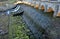 The dam of the breeding fish pond has a canal safety overflow similar to a weir. the water flows under a stone bridge with several